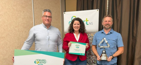 2023 award winner accepting their award with 2 divert ns staff