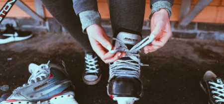  a person tying up their skates