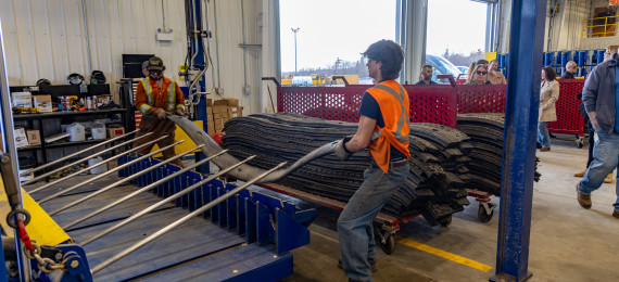 2 people working at a warehouse to create blasting mats
