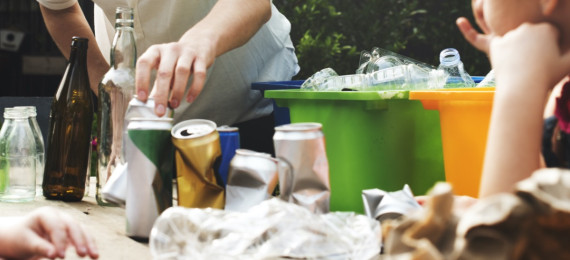 people sorting recycling into bins