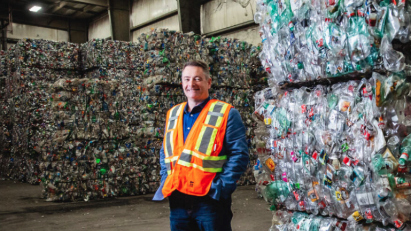 Divert NS CEO standing next to recycling in the warehouse