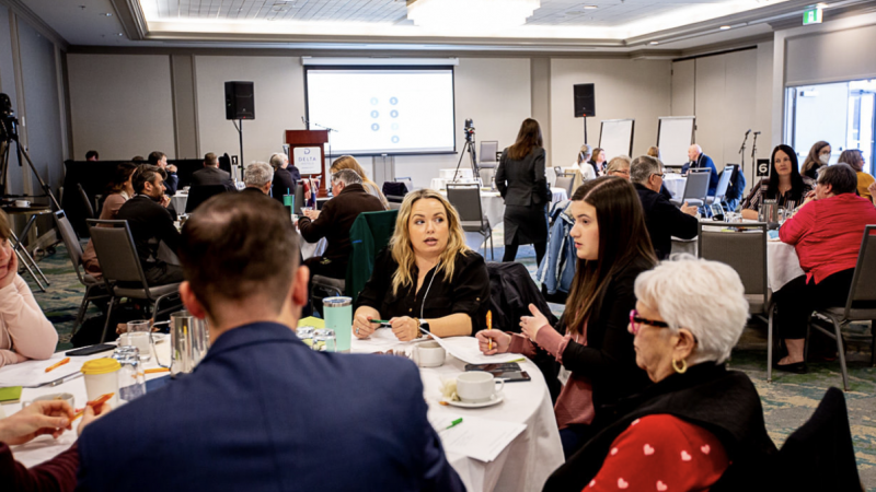 a room full of people at a conference