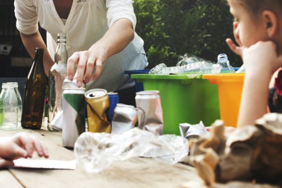 a person sorting recycling into bins
